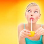 close-up-of-a-young-woman-sipping-juice